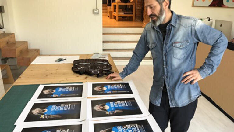Giovanni Motta at Megaborg in Verona, Italy, reviewing ad concept proofs.