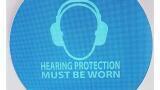 Weatherproof noise-activated hearing protection signs