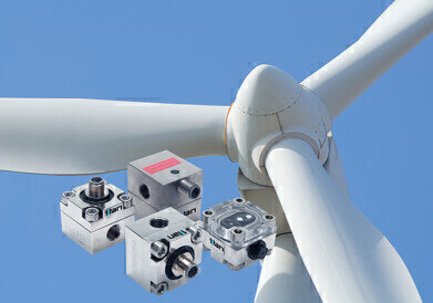 How do you monitor grease lubrication flow in wind turbines?